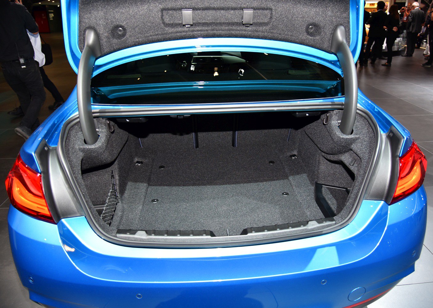 Spacious open trunk interior with lined surface and support bars