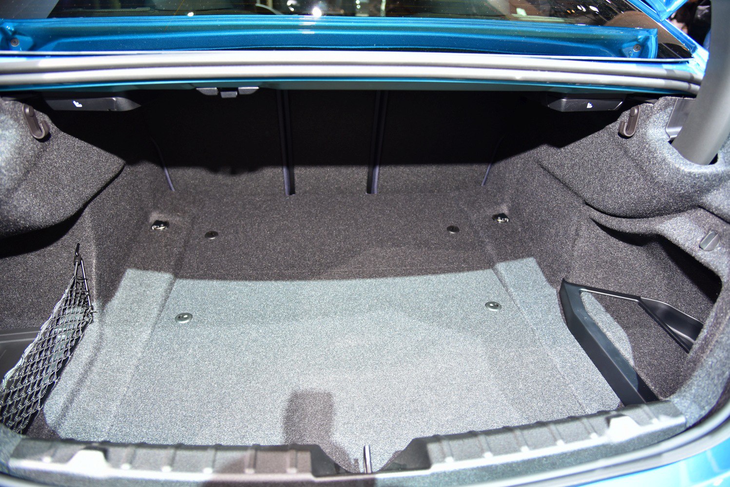 Spacious, carpeted trunk interior with side storage net and clean design