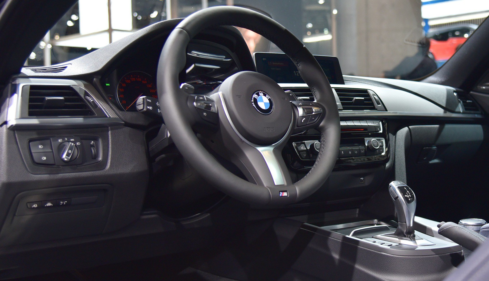 Steering wheel and gear shifter in a modern luxury coupe interior