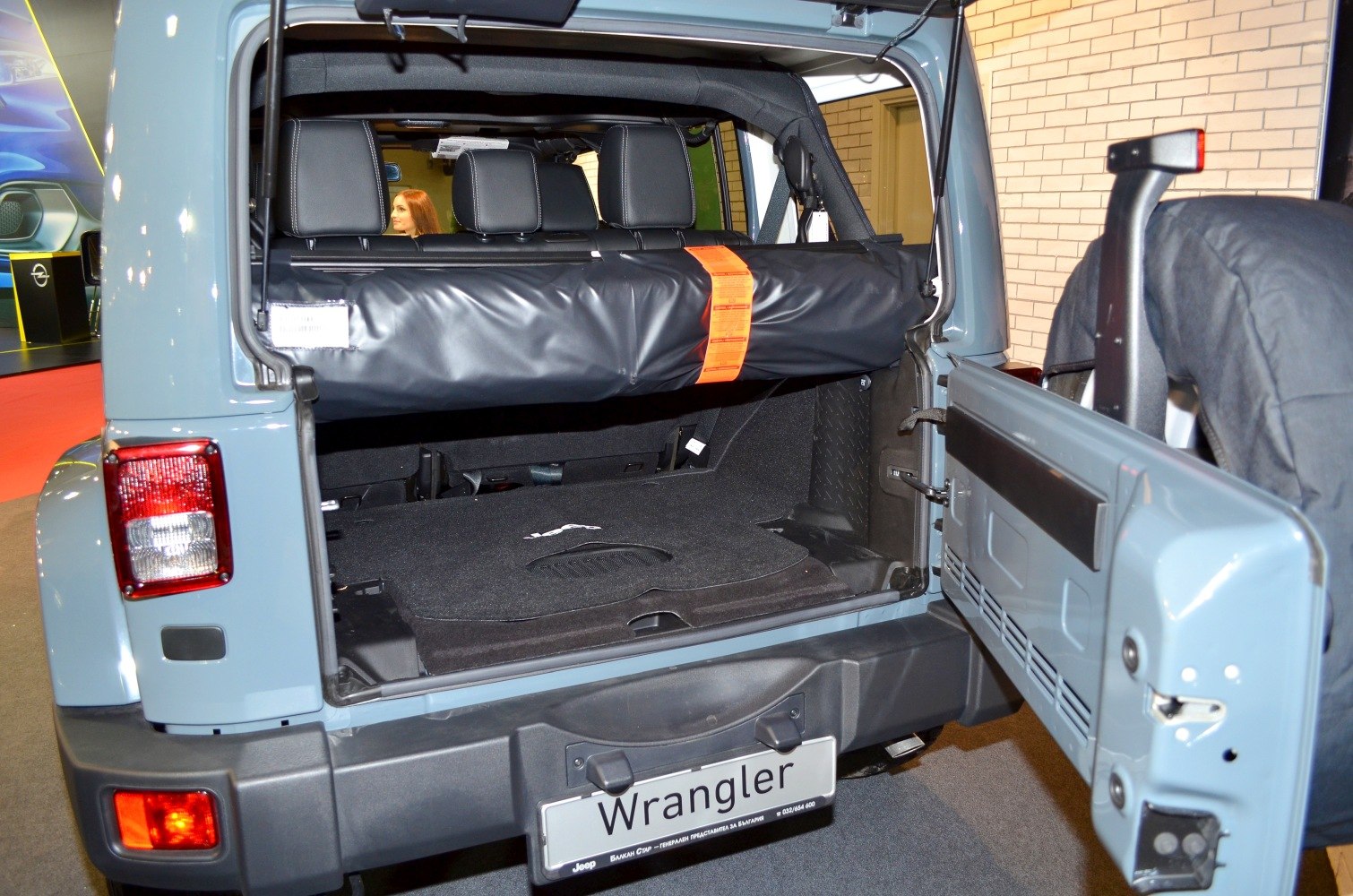 Rear cargo space with back seats and open rear door