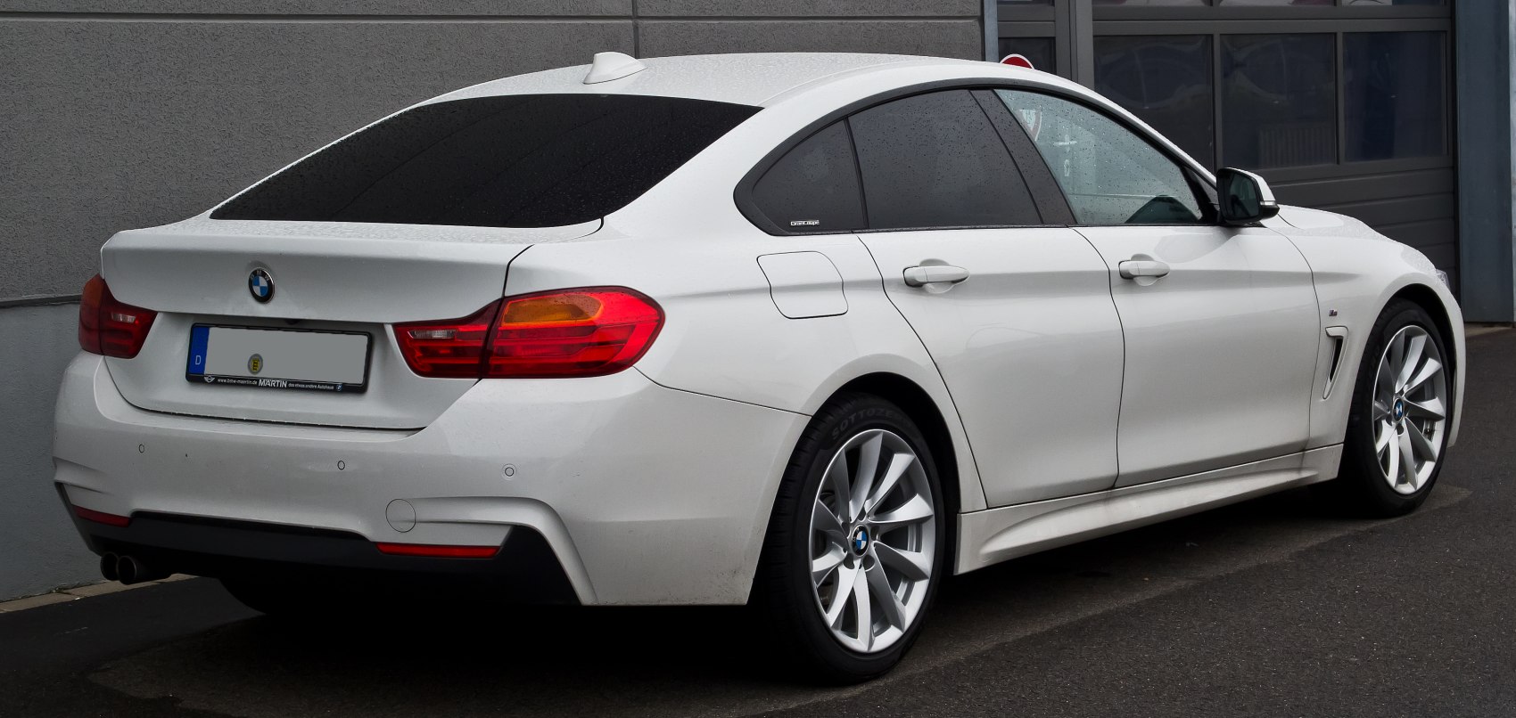 Sleek rear and side profile with prominent taillights and aerodynamic body lines