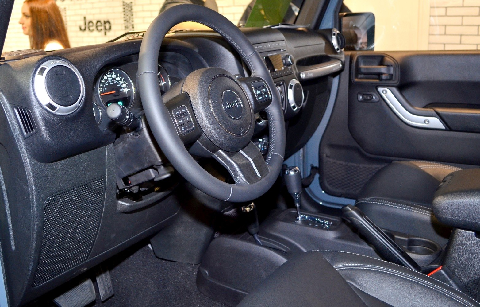 Steering wheel, dashboard, center console with gear shift and black upholstery