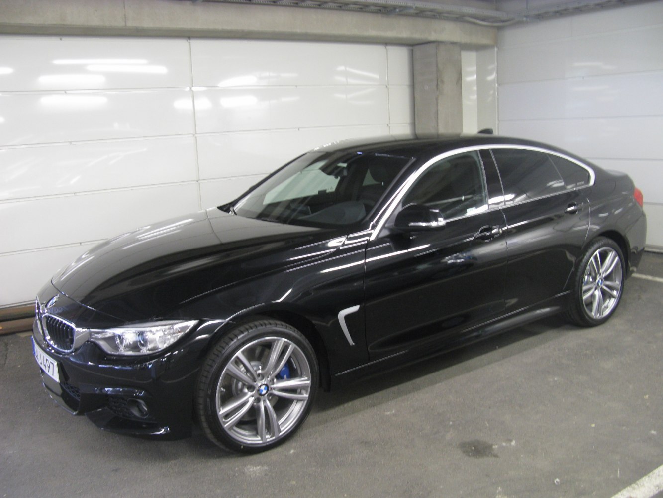 Sleek front and side view of a black 4-door luxury sedan with alloy wheels