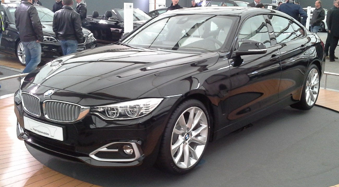 Front side view of a modern luxury sedan with distinctive grille and alloy wheels
