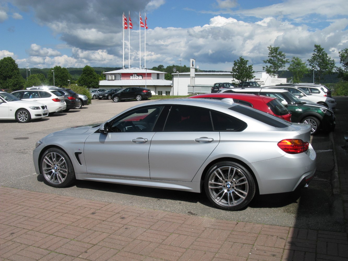 Side profile showing coupe-style roofline and sporty alloy wheels