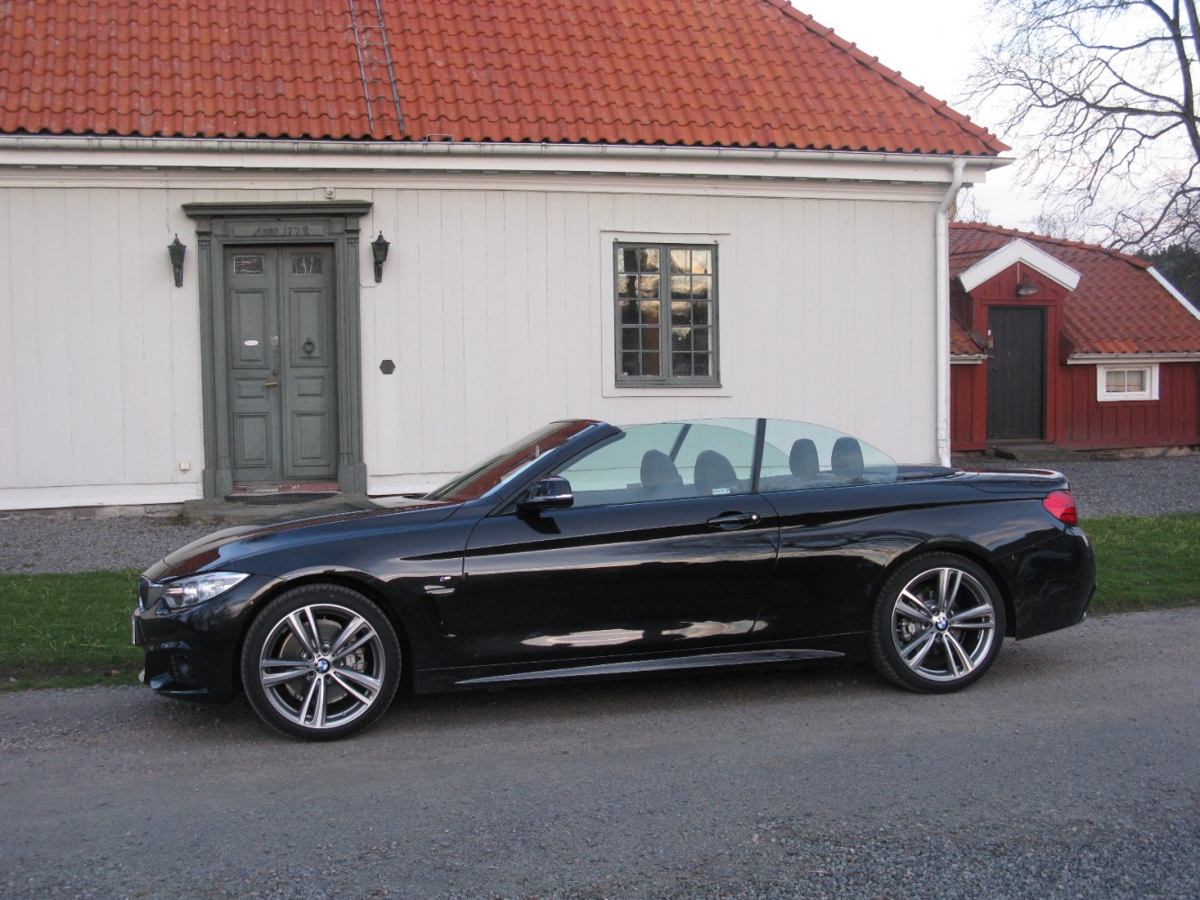 Side profile of black convertible with alloy wheels
