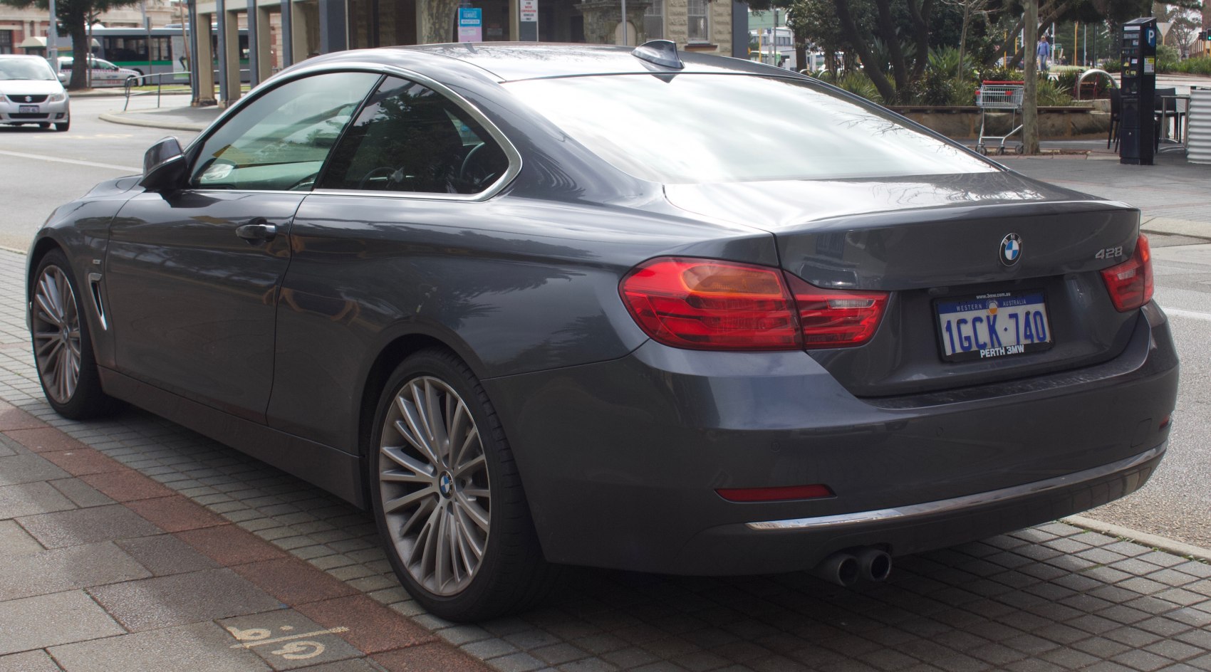 Rear side view of a modern coupe with distinctive taillights and alloy wheels