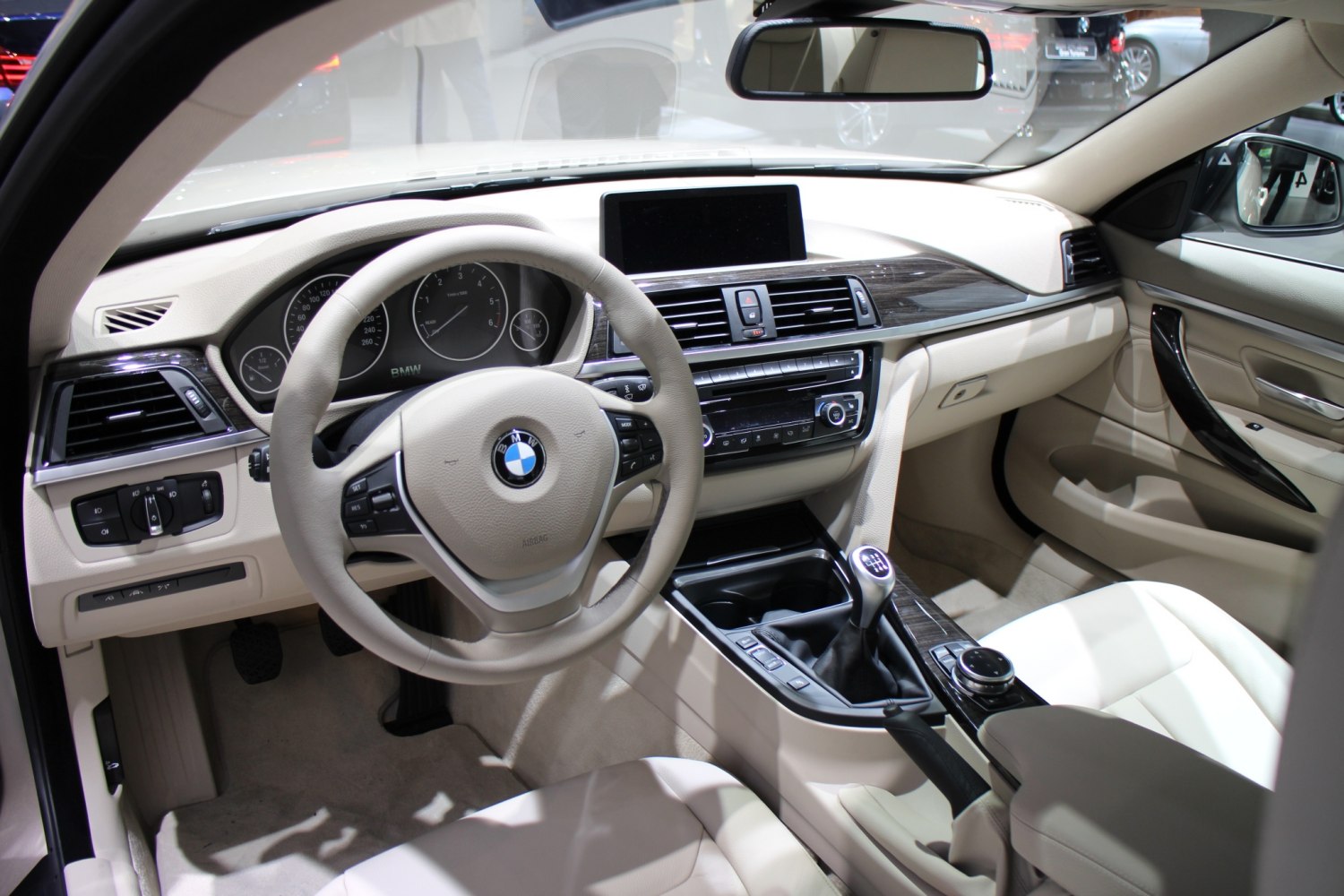 Beige car interior dashboard with manual gearshift and steering wheel