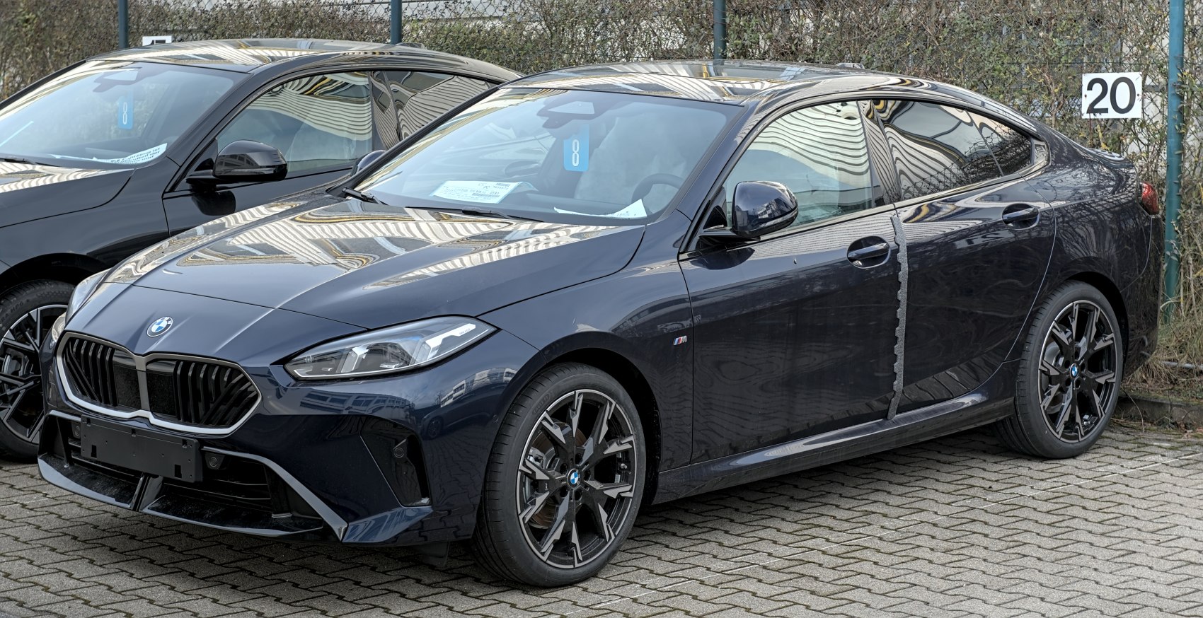 Front and side profile of a luxury sporty sedan with distinctive grille and sleek lines