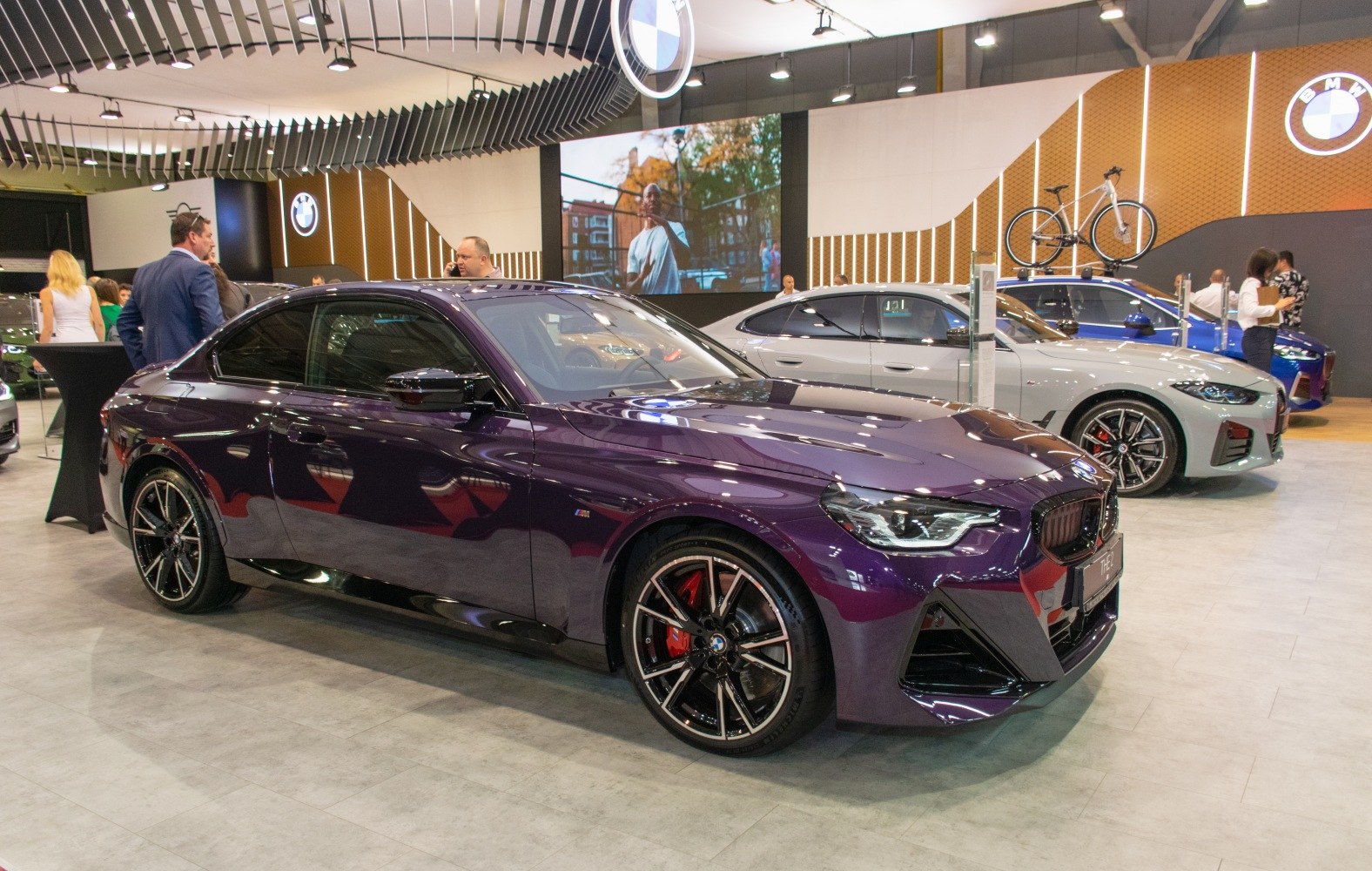 Side-front view of purple coupe with sporty wheels and aggressive headlights