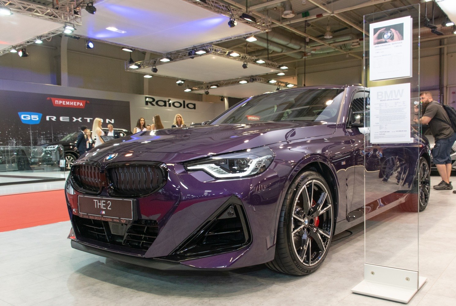 Front view of sporty coupe with blacked-out grille and multi-spoke wheels