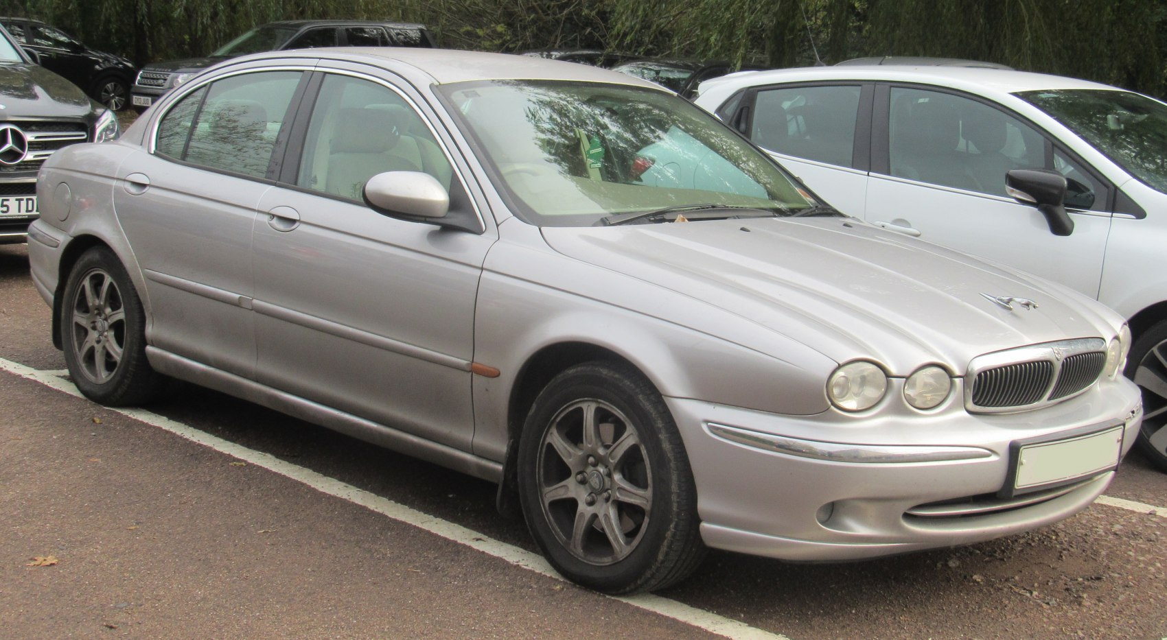 Front and side view with dual round headlights and chrome grille