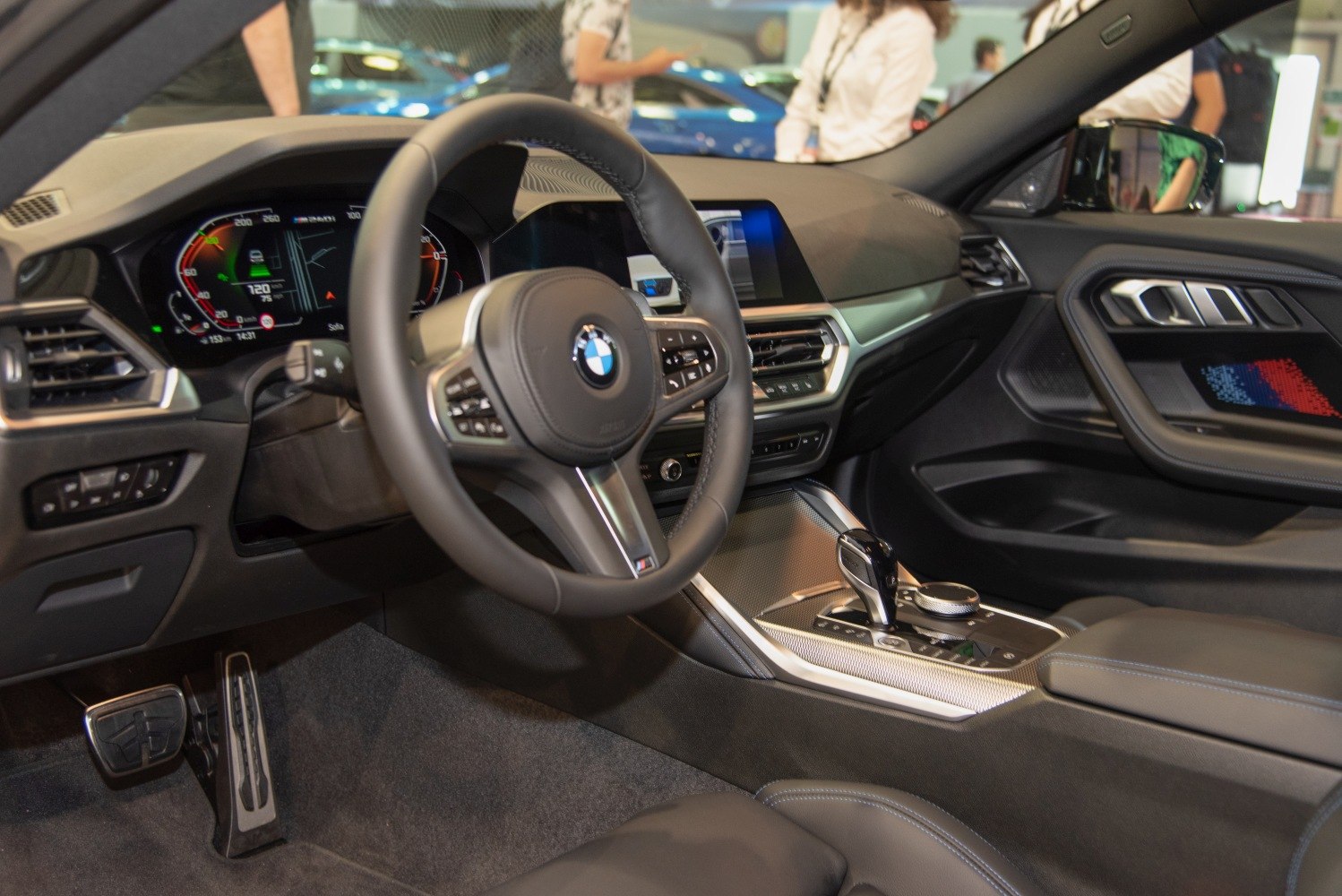 Digital instrument cluster and multifunction steering wheel in luxury coupe interior