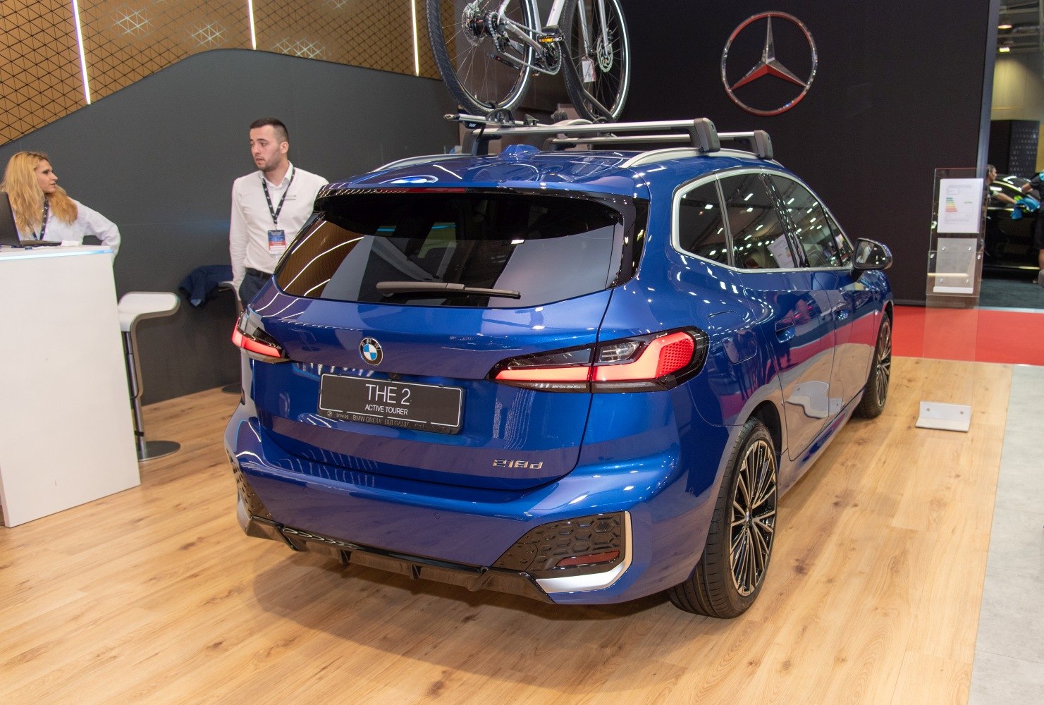 Rear view of compact MPV with roof rack and bicycle mount