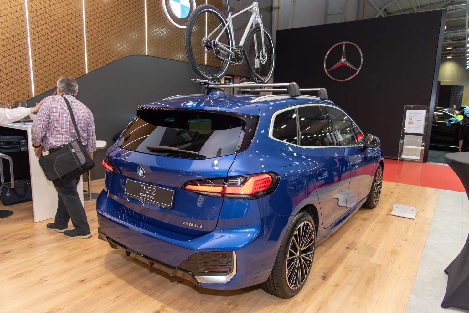 Rear view of blue hatchback with roof bike rack and alloy wheels