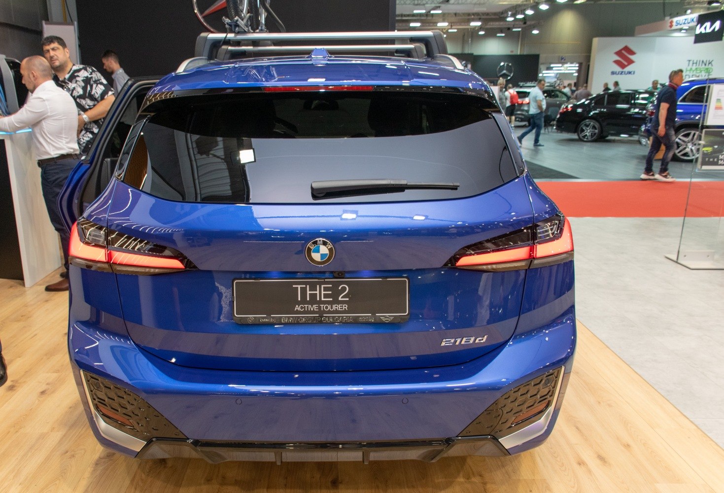 Rear view of a blue hatchback with distinctive LED tail lights and parking sensors.
