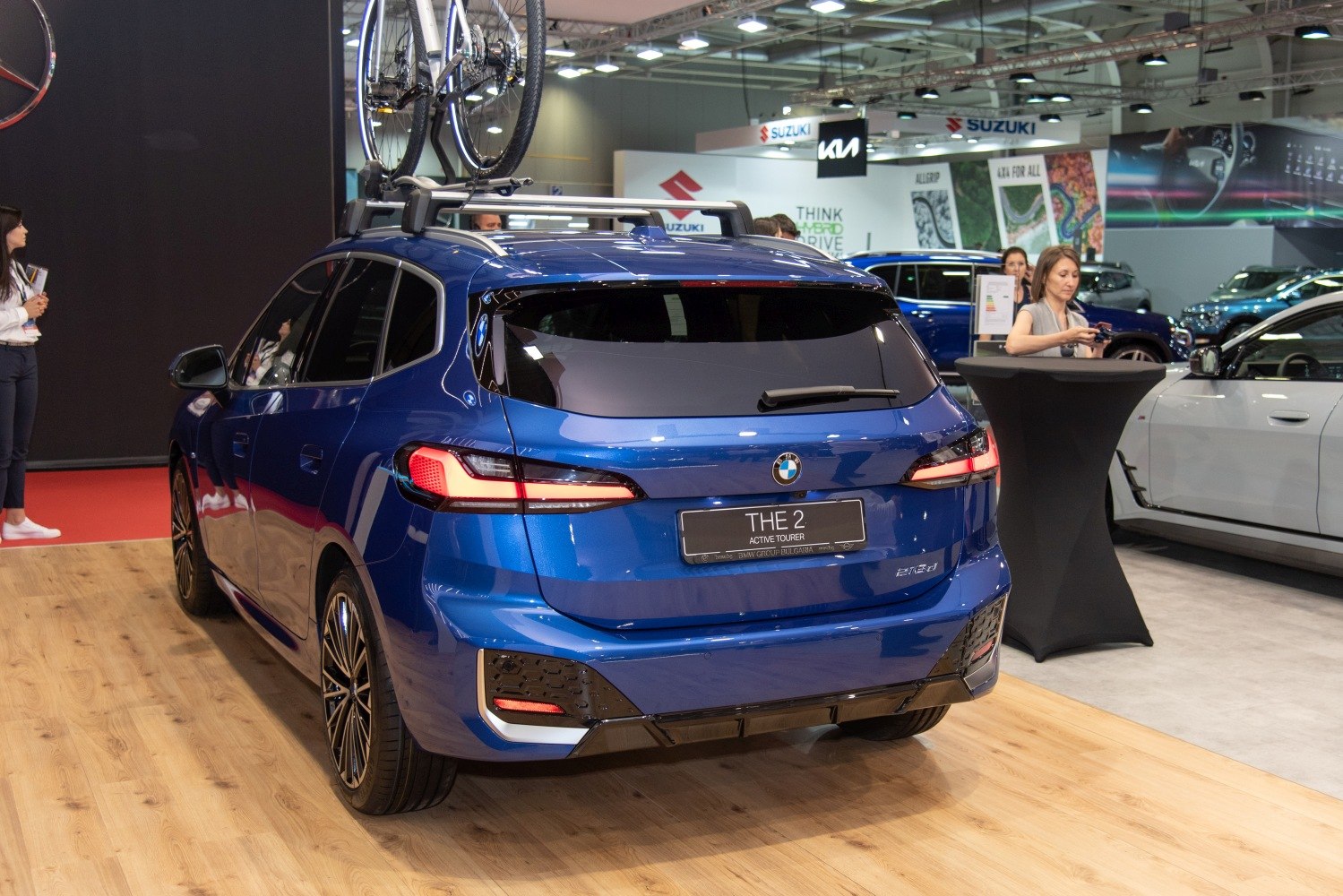 Rear view of blue SUV with roof bike rack and modern taillights