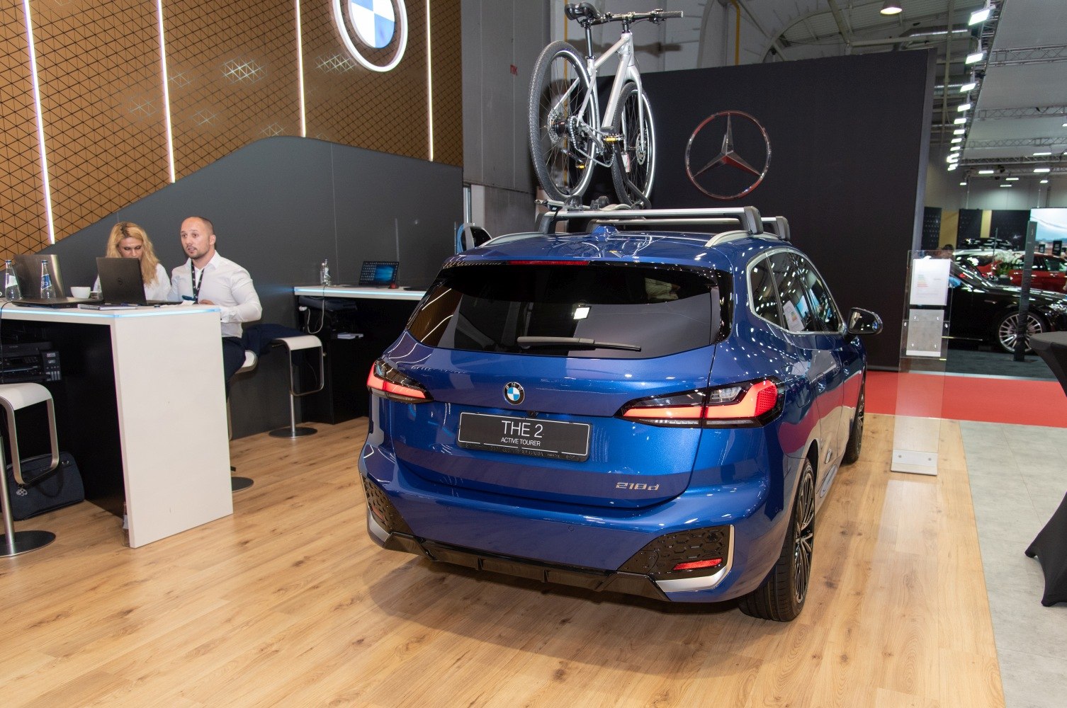 Rear of blue hatchback with roof-mounted bike rack and modern taillights