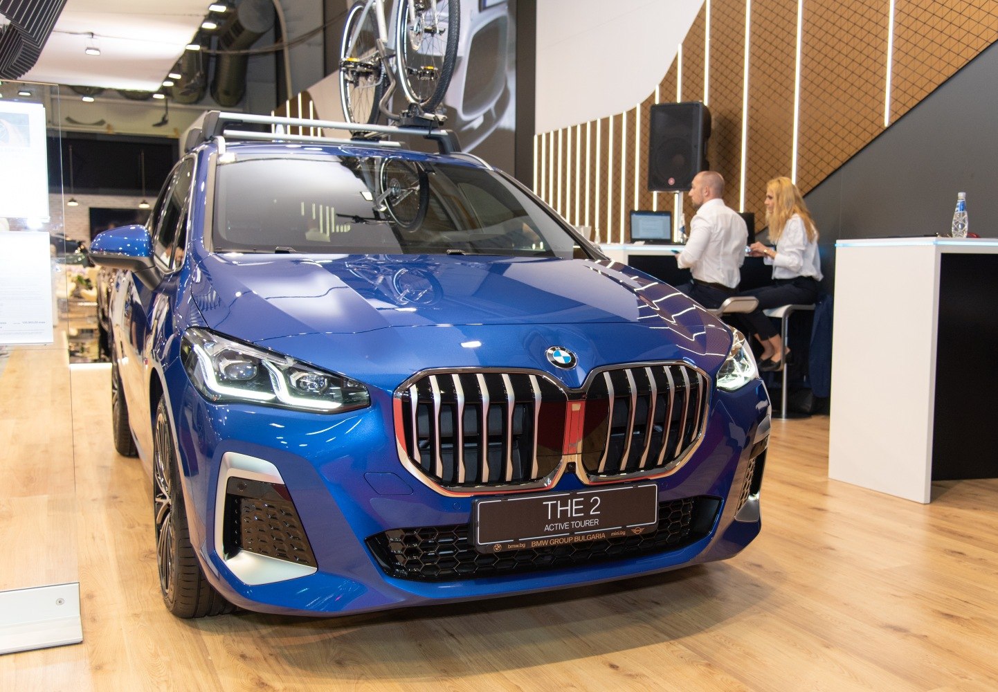 Modern front grille and LED headlights of a blue vehicle
