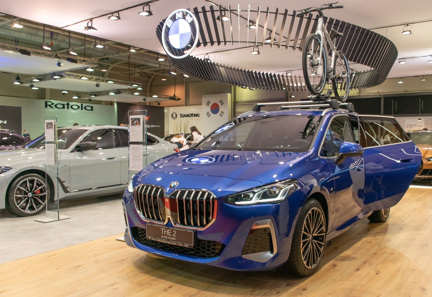 Blue sporty wagon with roof-mounted bike rack and open front door