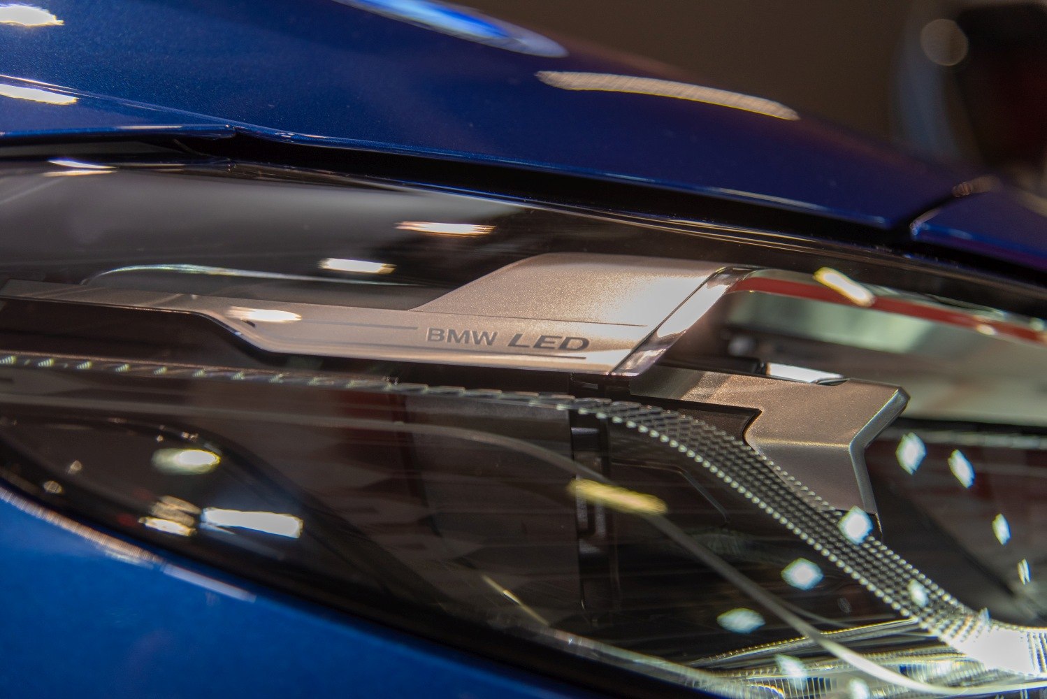 Close-up of LED headlight with BMW branding