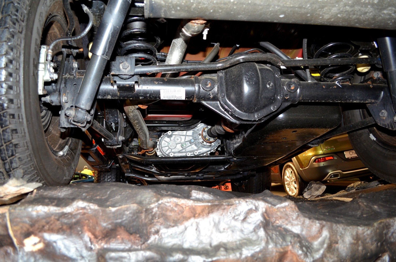 Underbody view showing suspension, axle, coil springs, and shock absorber