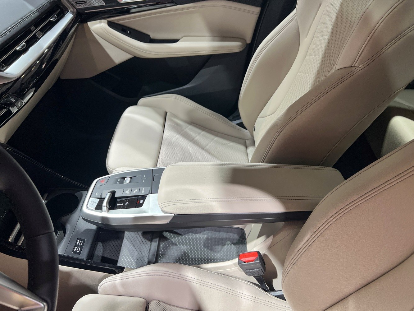 Beige leather seats with modern center console and control buttons