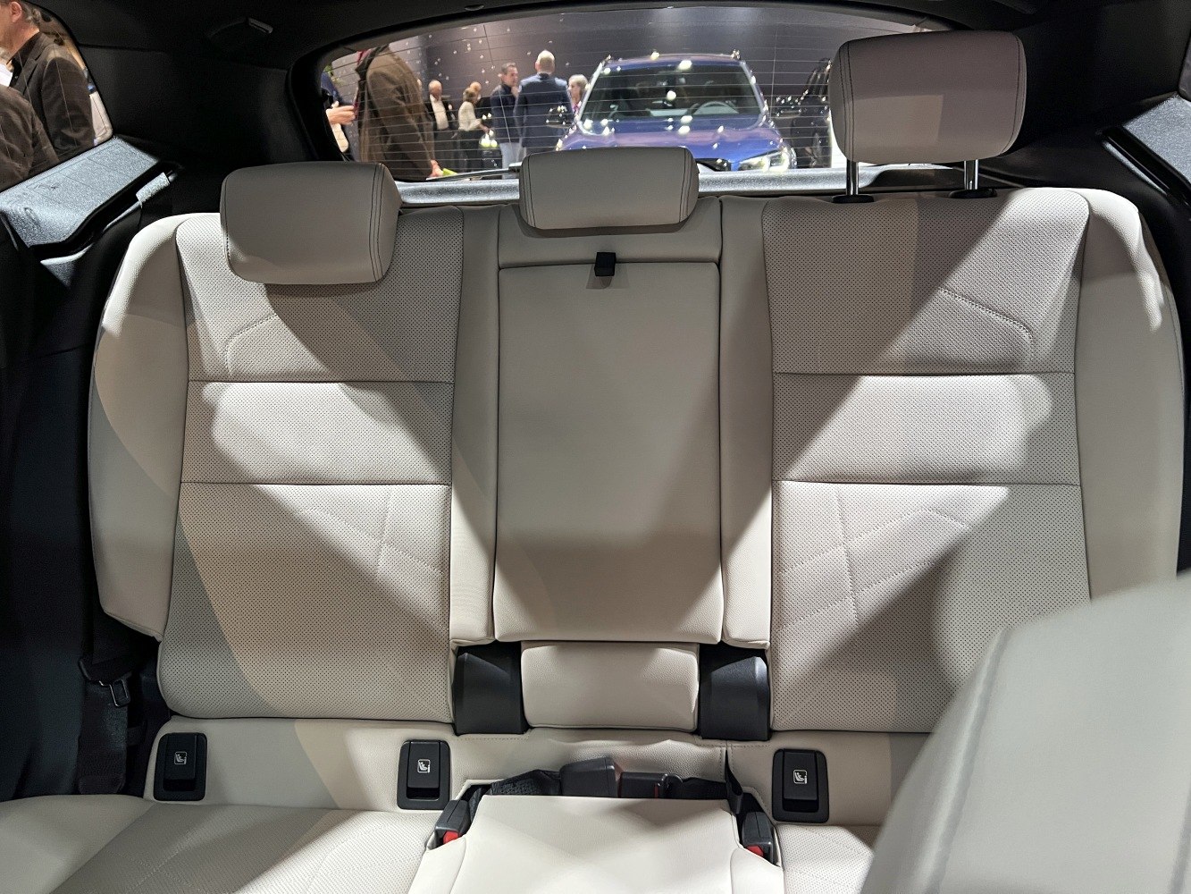 Rear seats with ergonomic headrests and premium beige upholstery.