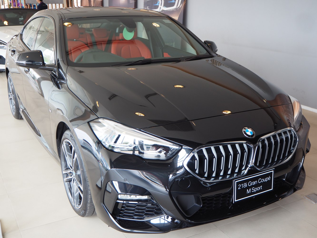 Front view with headlights and kidney grille of sleek black Gran Coupe
