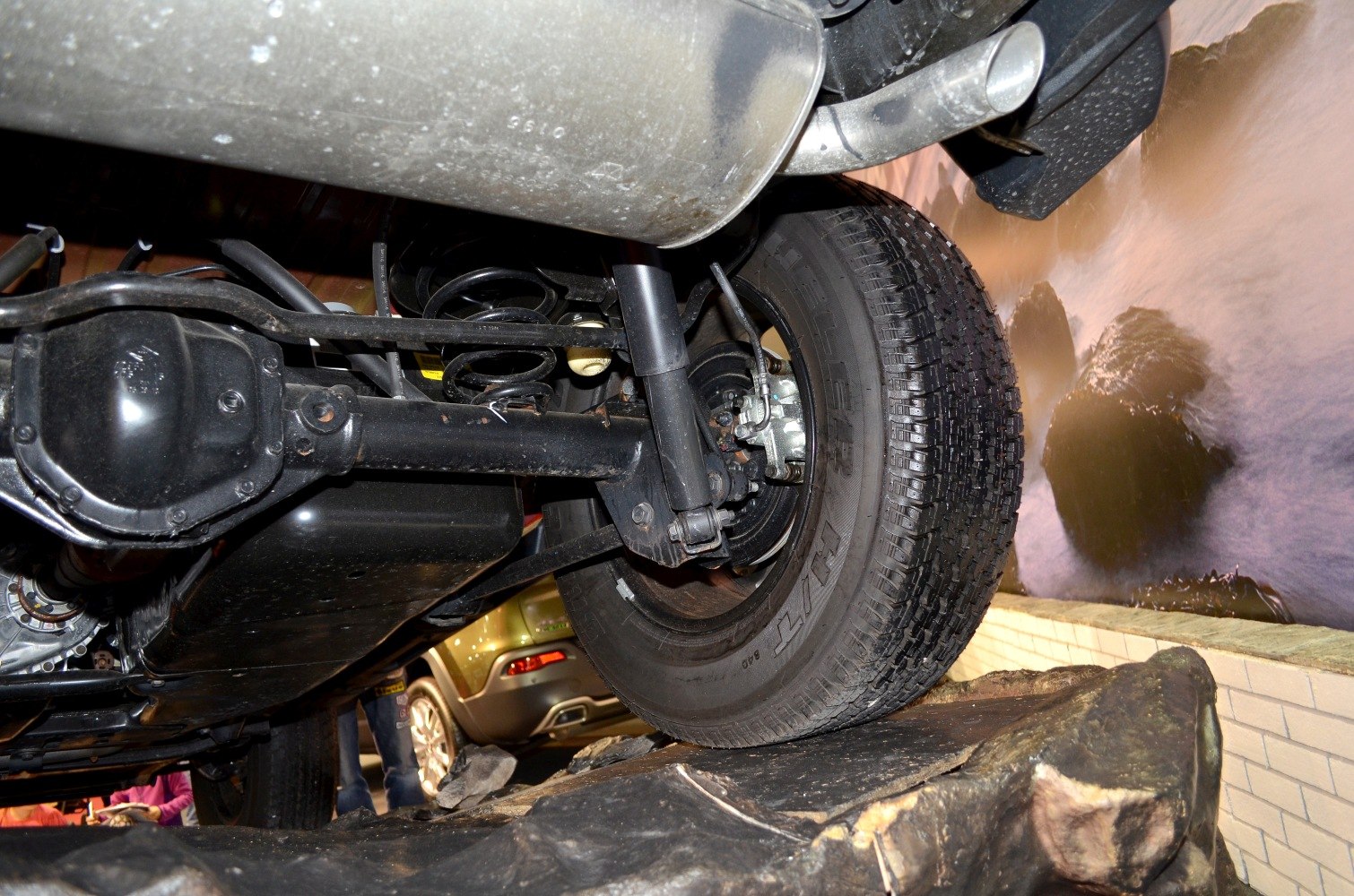 Rear suspension, axle, coil spring, shock absorber, exhaust close-up