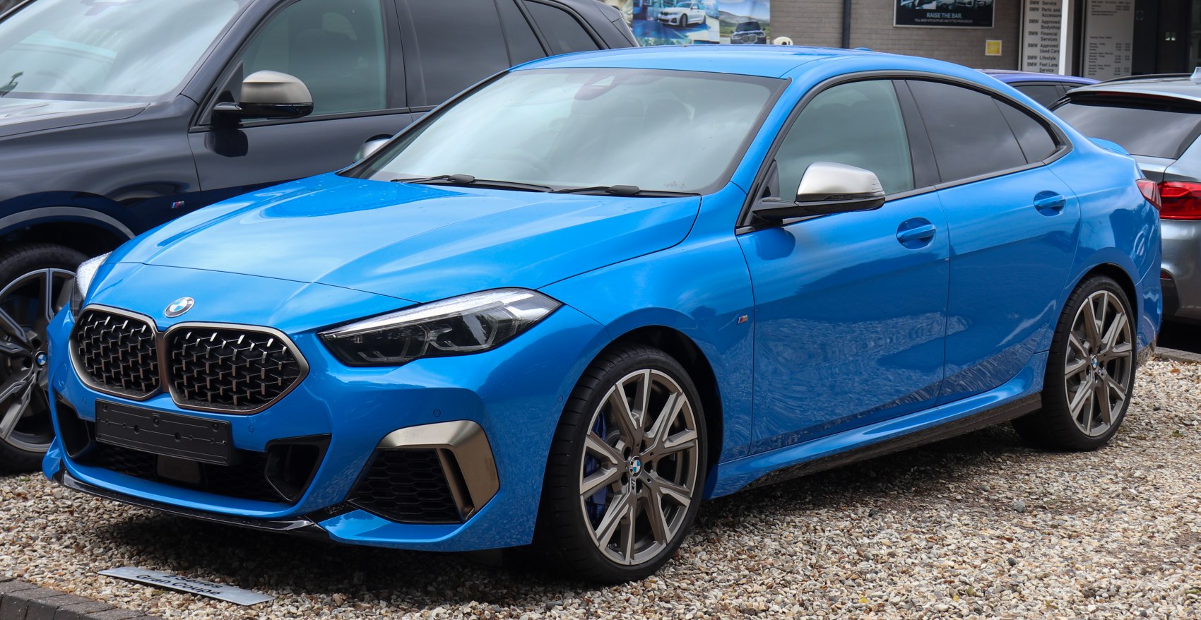 Blue sporty sedan with distinctive kidney grille and sleek headlights