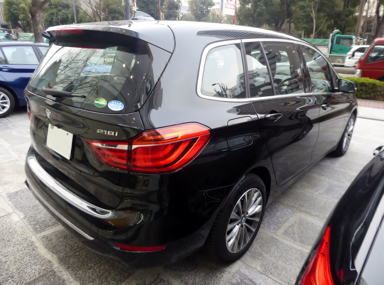 Rear-side view with LED tail lights and multi-door hatchback design