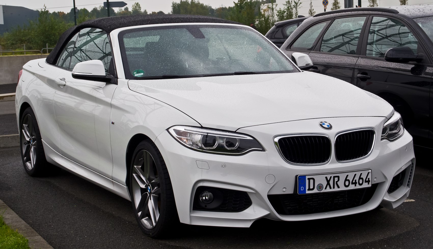 Front view of convertible with soft top roof and alloy wheels