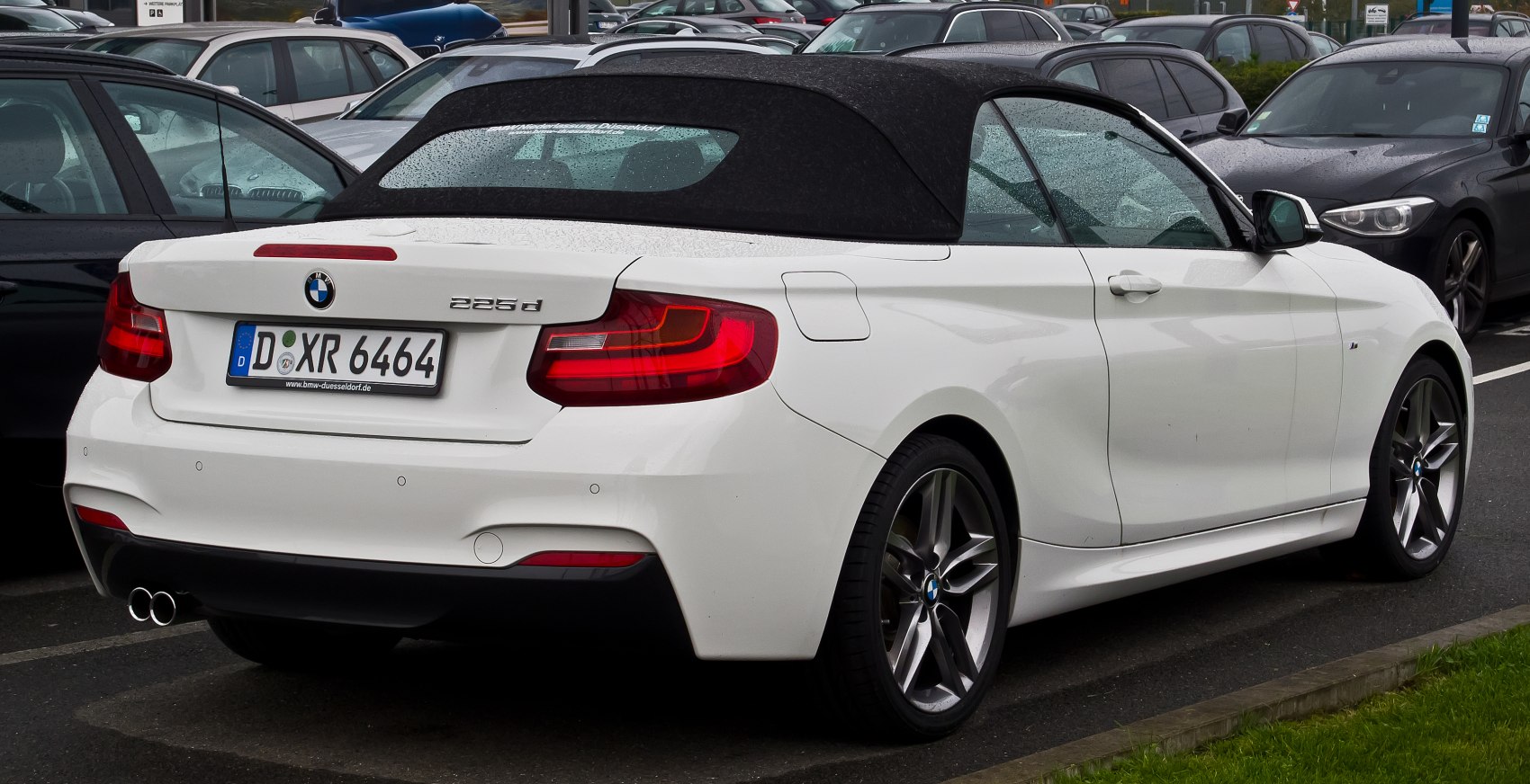 Rear view of convertible with soft top and dual exhaust