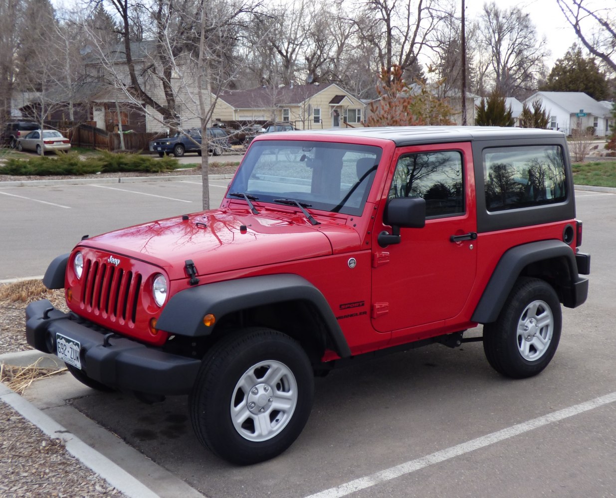 Red SUV with hardtop, rugged off-road styling.