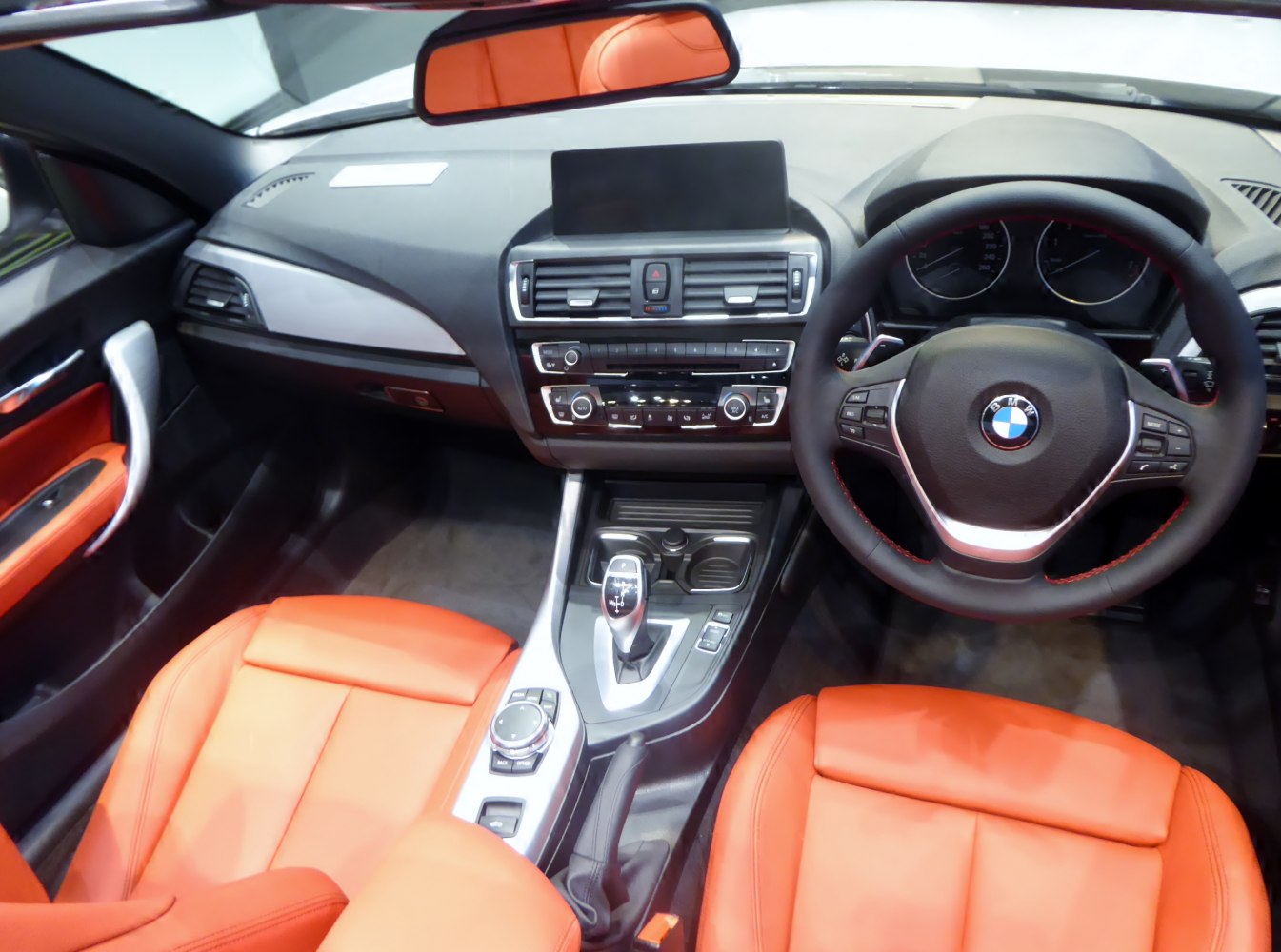 Interior with orange leather seats and modern dashboard design