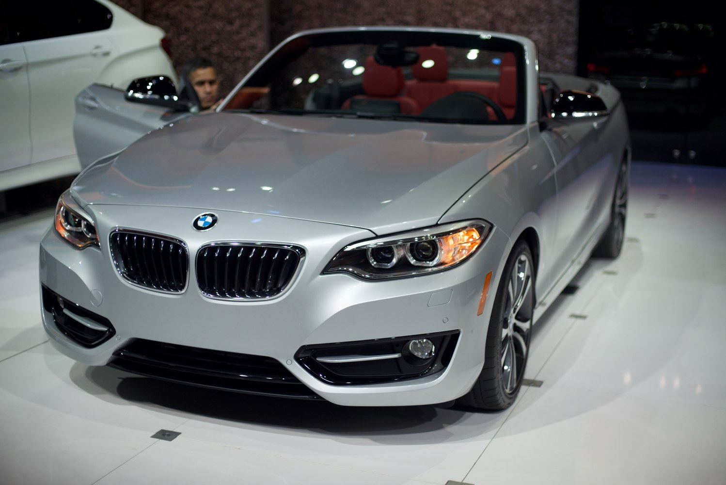 Front view of silver convertible with LED headlights and open roof