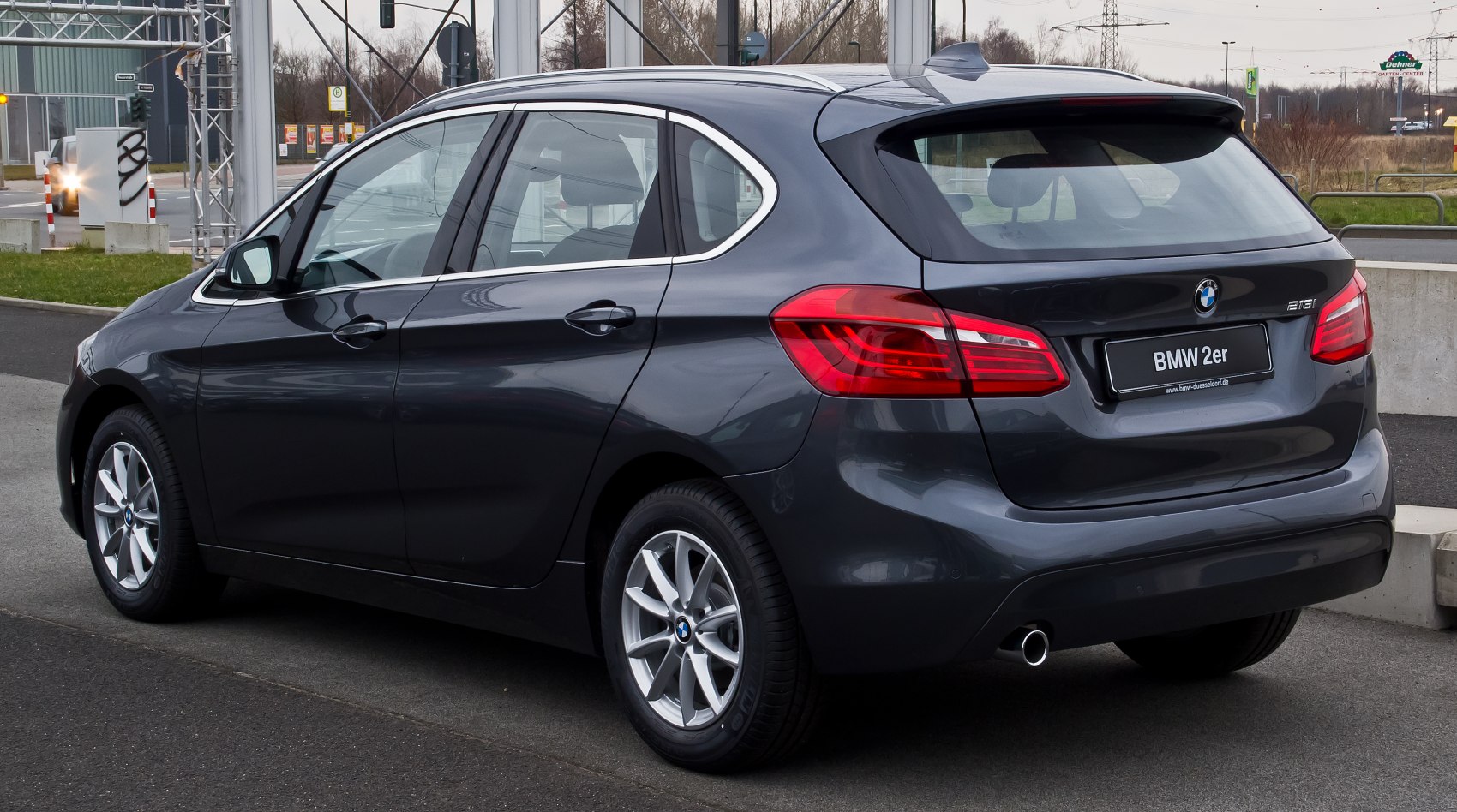 Rear and side view of compact MPV with distinctive tail lights and alloy wheels
