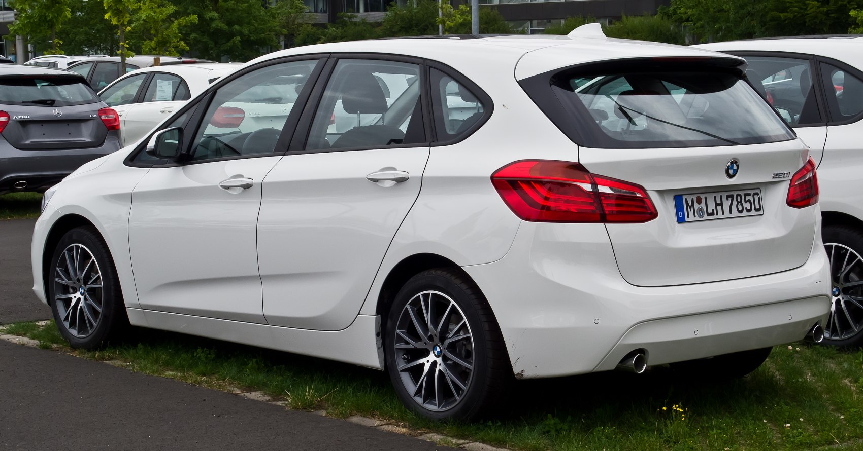 Rear side view of a white hatchback with alloy wheels.