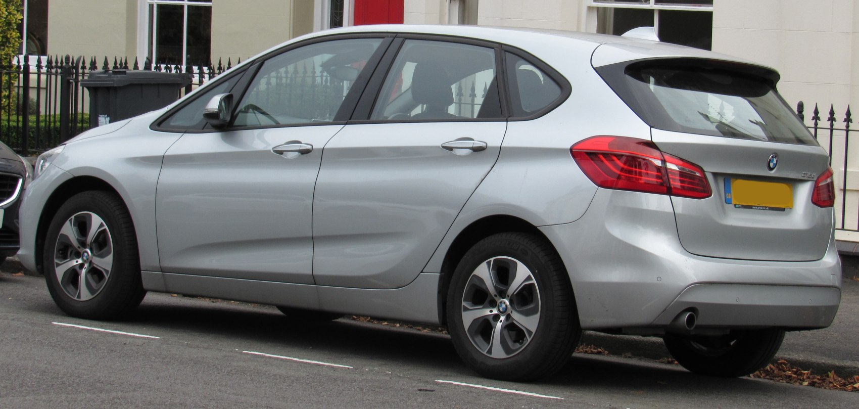 Rear side view of hatchback with alloy wheels and sleek silver body