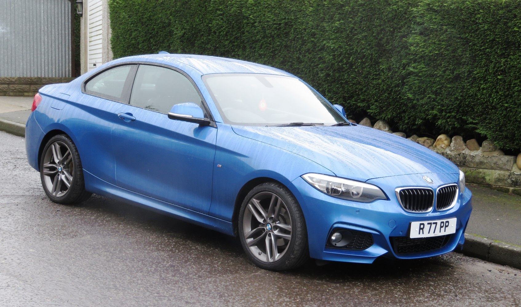 Blue coupe with sporty front design and alloy wheels