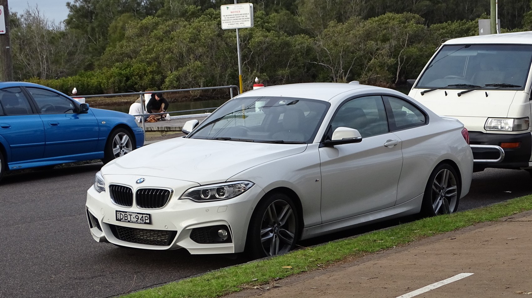 Front-side view with dual headlights and kidney grille