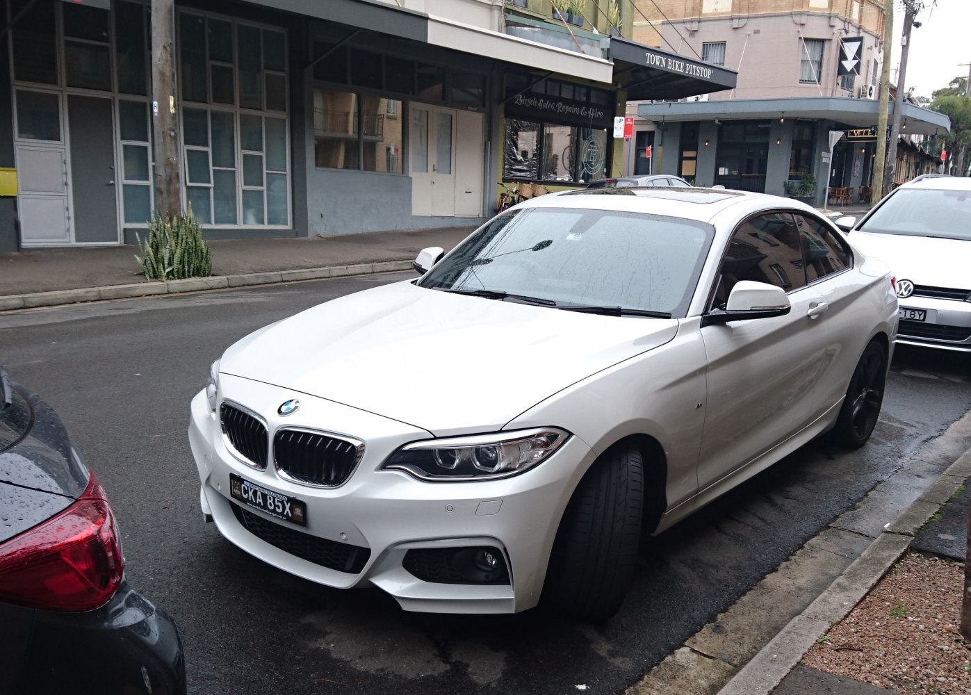 White BMW coupe front angled view with kidney grille and M Sport bumper