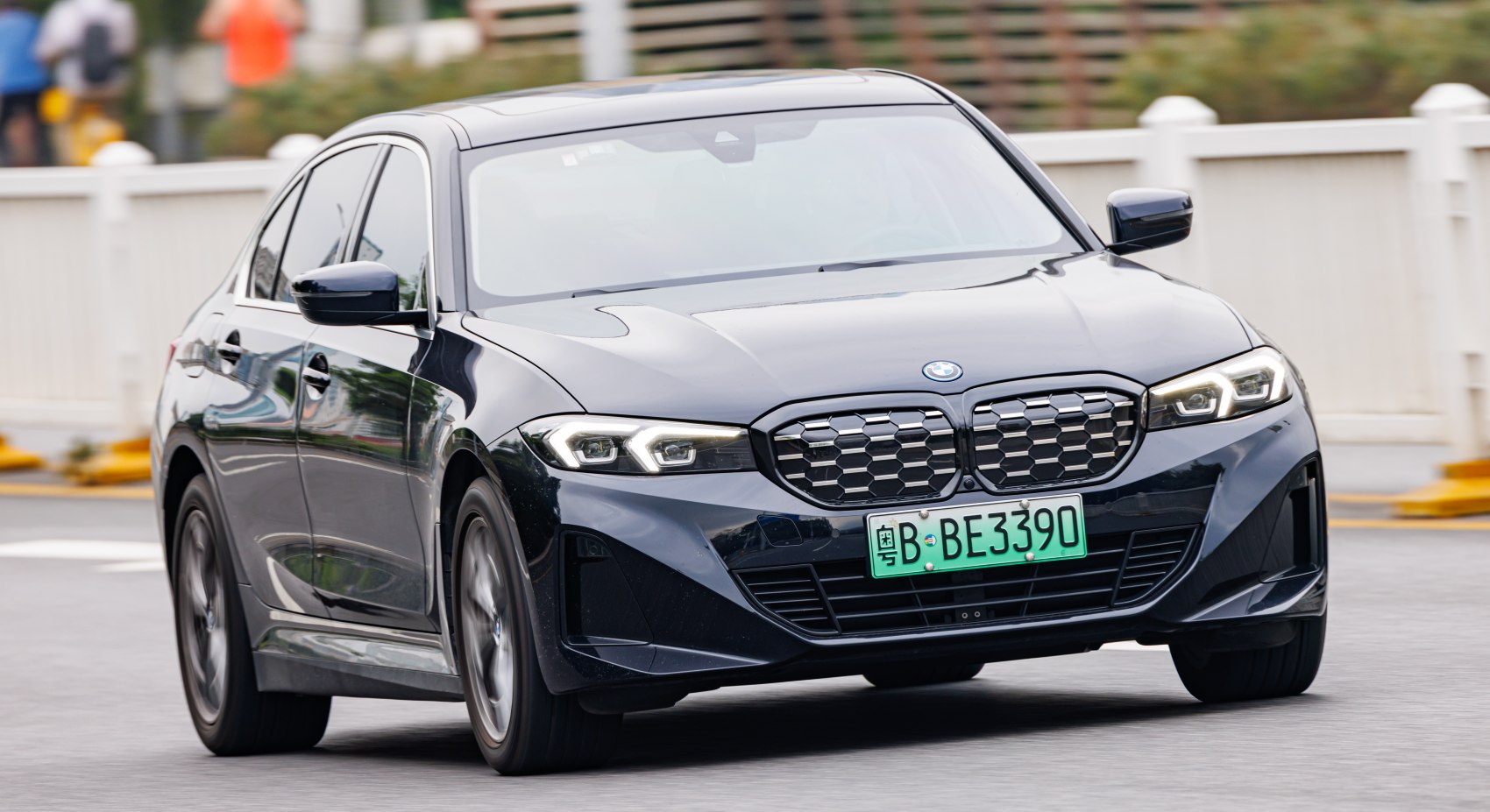 Front grille and LED headlights of a sleek electric sedan