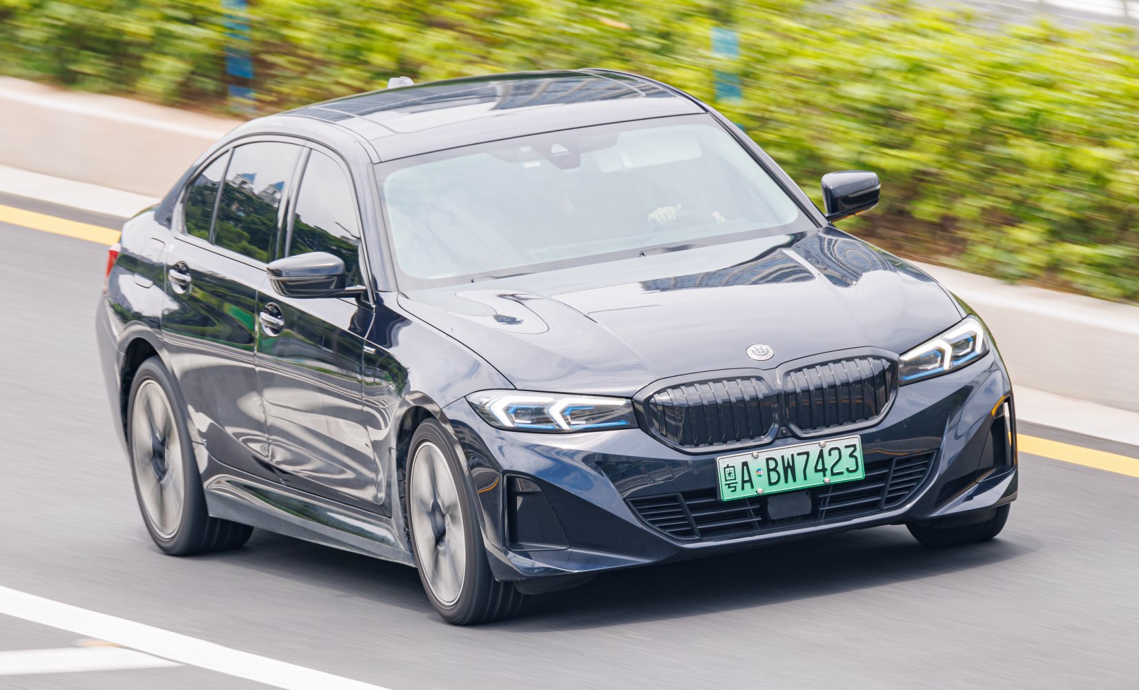 Front view of black sedan with distinctive kidney grille and LED headlights