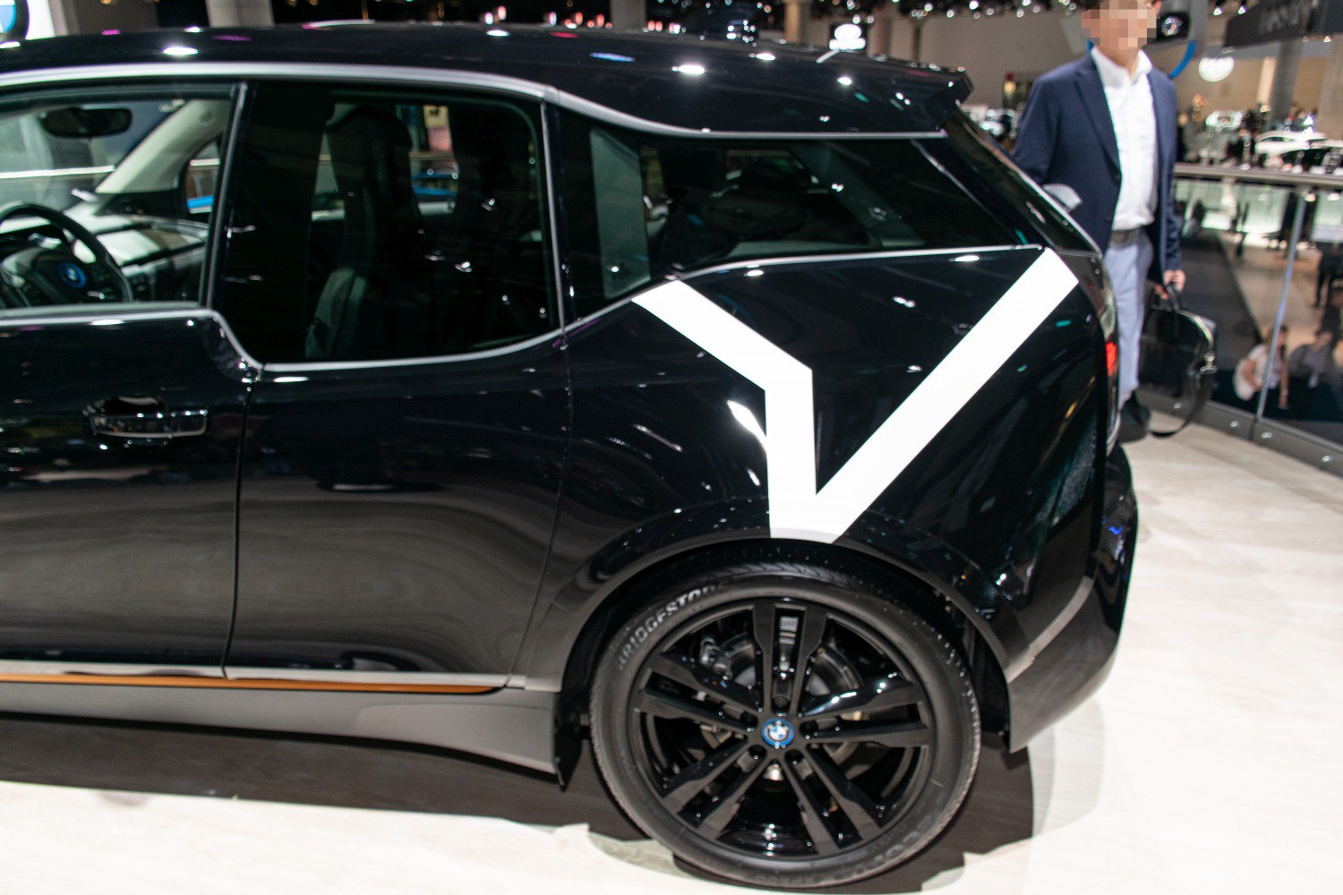 Rear side view of car with black alloy wheel and door design