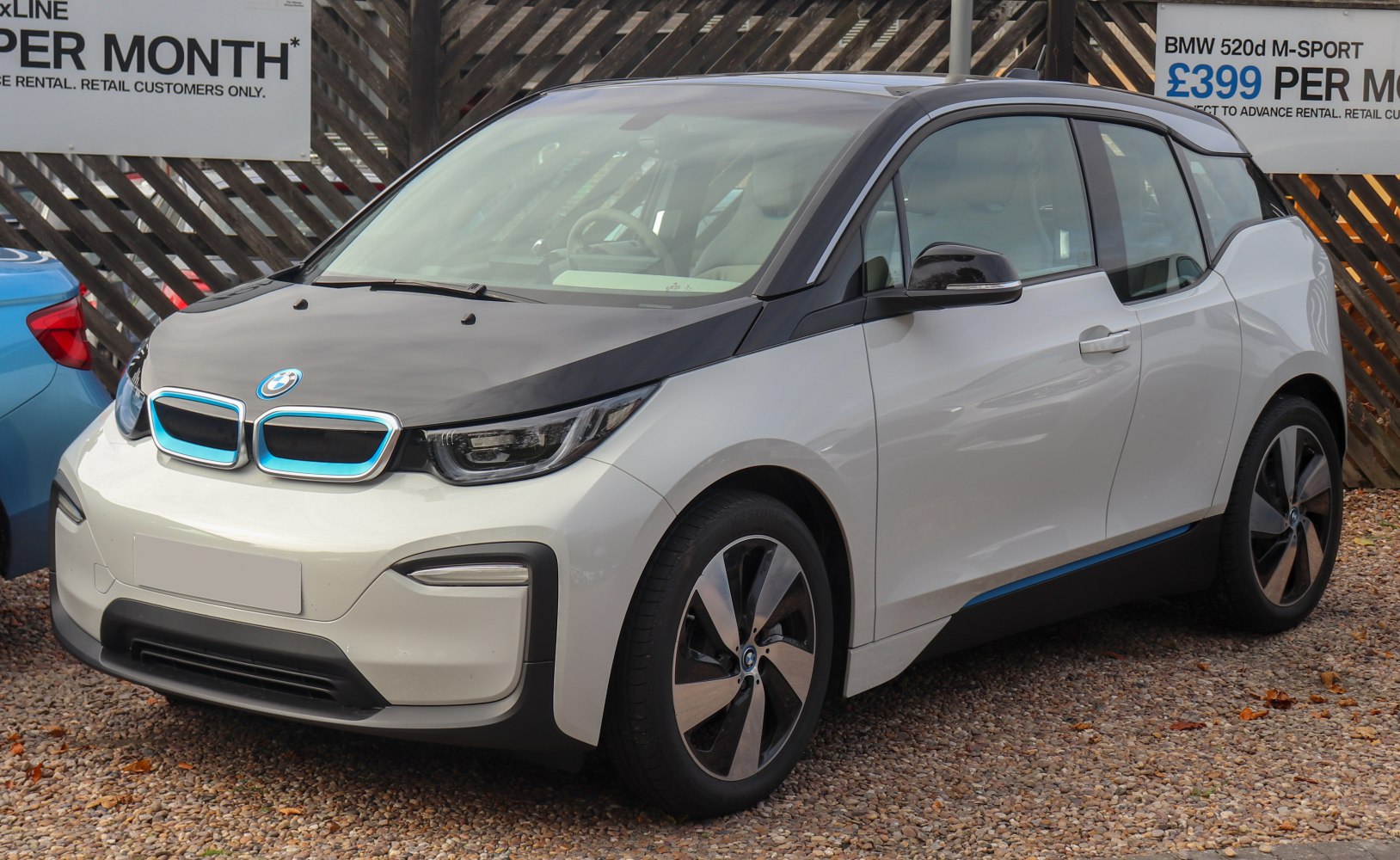 Front-side view of electric hatchback with kidney grille and black hood