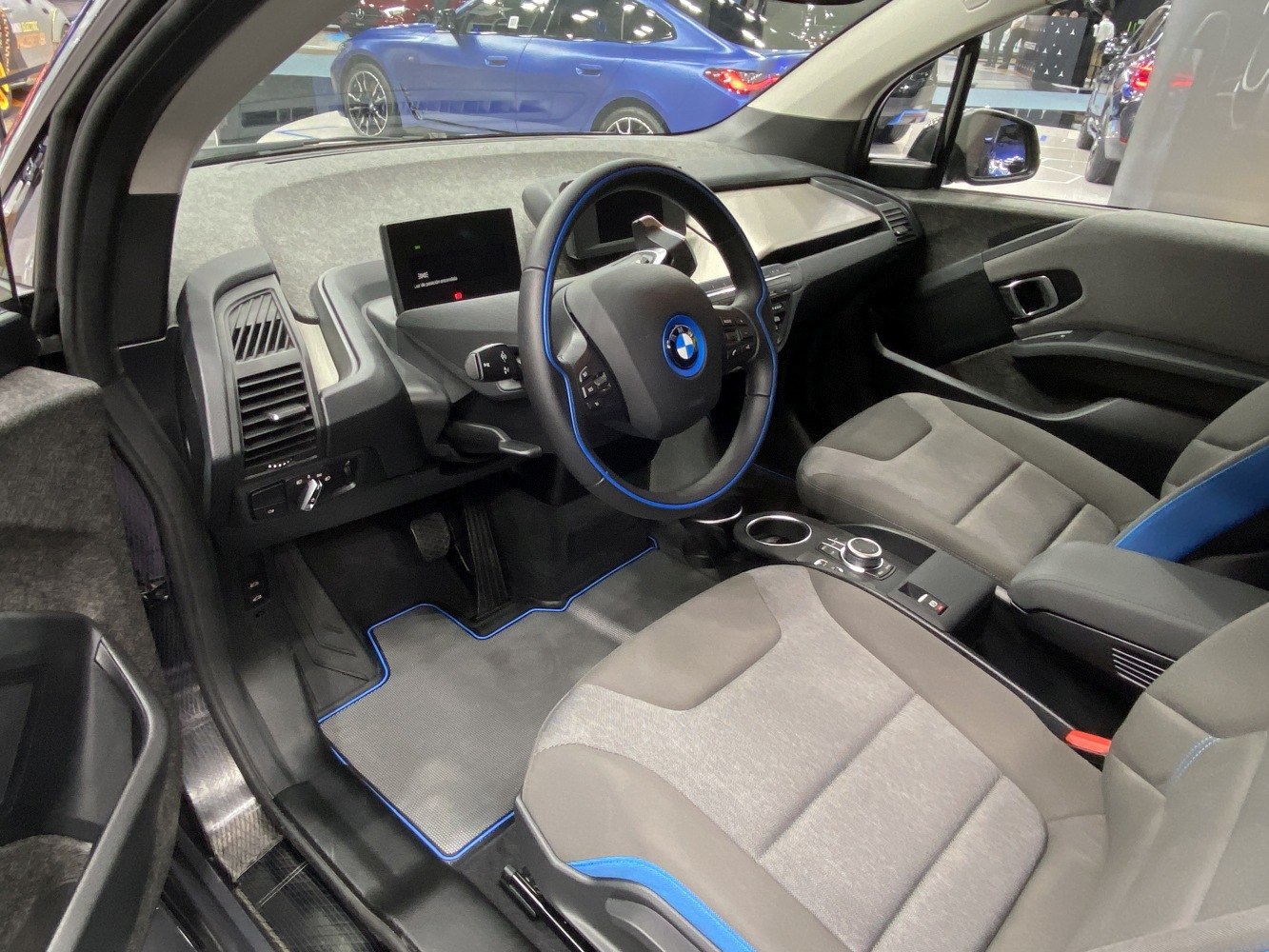 Modern interior with digital dashboard and blue-accented steering wheel