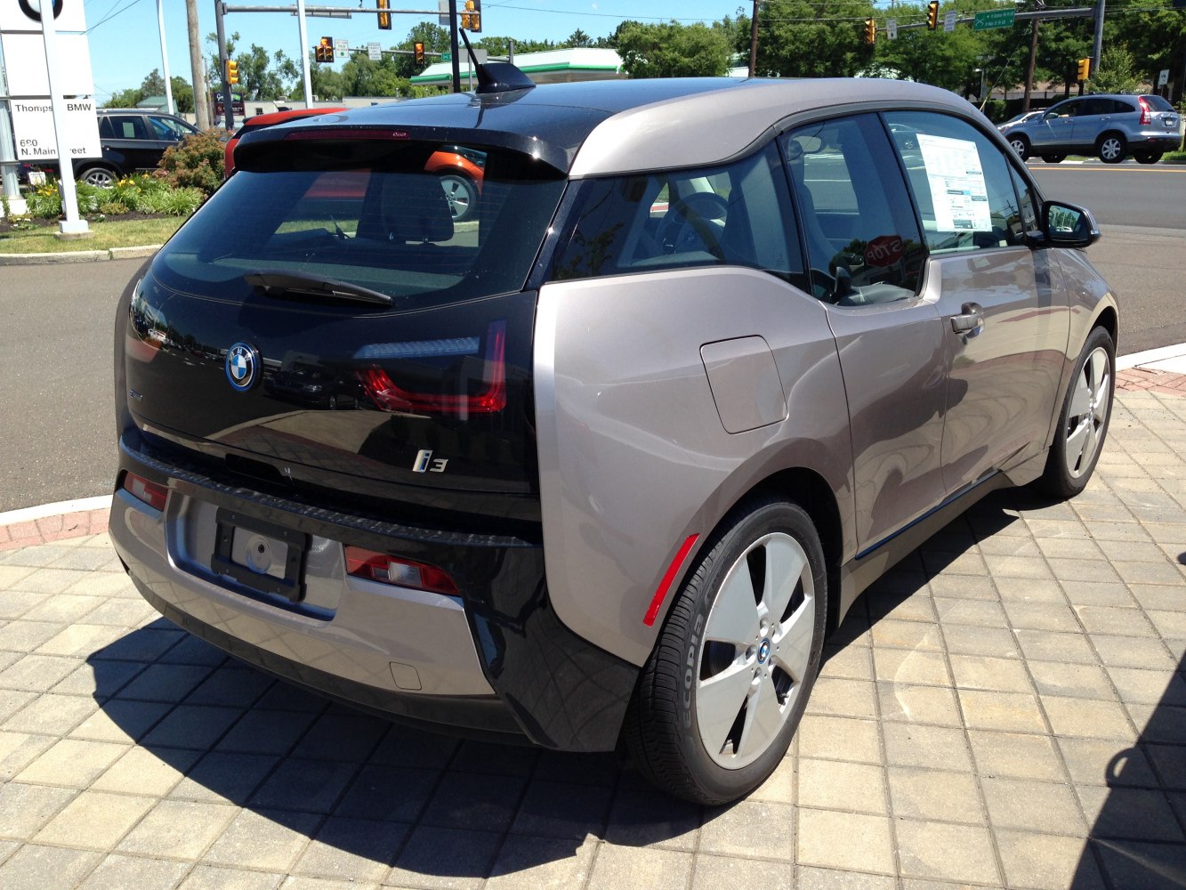 Rear and side view of a compact electric hatchback with distinctive taillights and window design