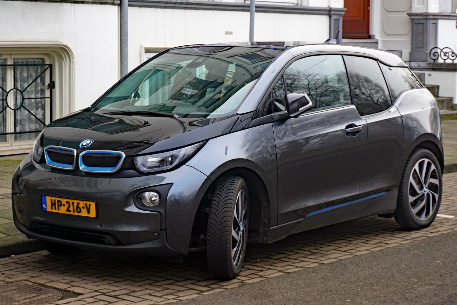 Front side view showcasing kidney grille and sleek headlight design